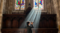 a beam of white light carves through paris’ historical chapel