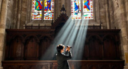 a beam of white light carves through paris’ historical chapel